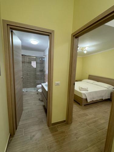 a bedroom with a bed and a bathroom with a mirror at Da Nonna Maria - Belvedere in Celano