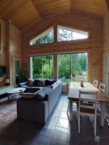 a living room with a couch and a table at Holiday Home Amero purnu 4 in Kolinkylä