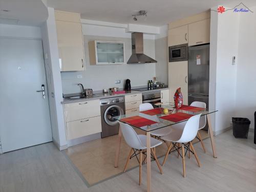 a kitchen with a table and chairs in a room at MarMédano Apartamento 3 in El Médano