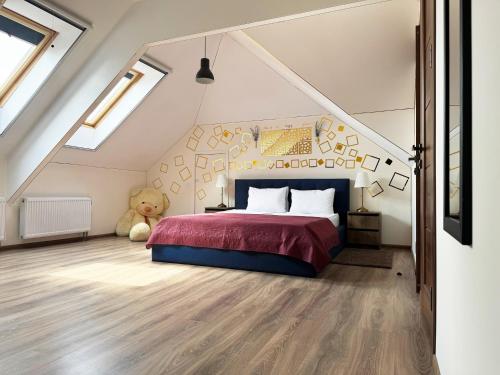 a bedroom with a bed and a teddy bear at SIGNEEV'S Villa in Kyiv