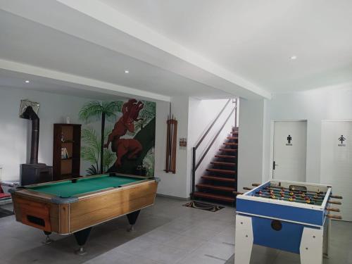 a room with a pool table and a staircase at Cabañas DELUXE DUNAS DEL ESTE in Punta Colorada