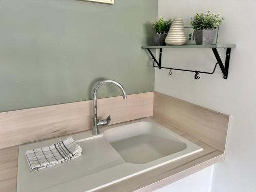 a kitchen counter with a sink in a kitchen at Maison - 2 chambres - Terrasse - Babyfoot in Verton
