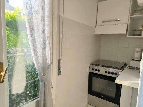 a small kitchen with a stove and a window at le case di nonna Piera in Lecco