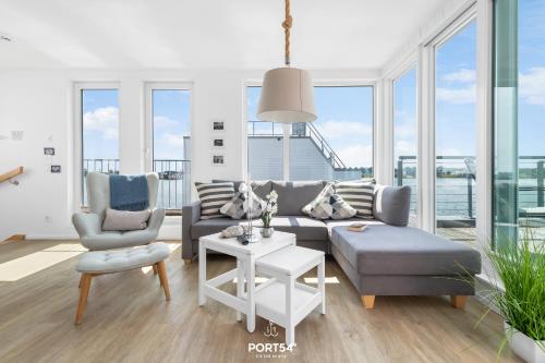 a living room with a couch and a chair at Ferienhaus Key West Olpenitz in Olpenitz