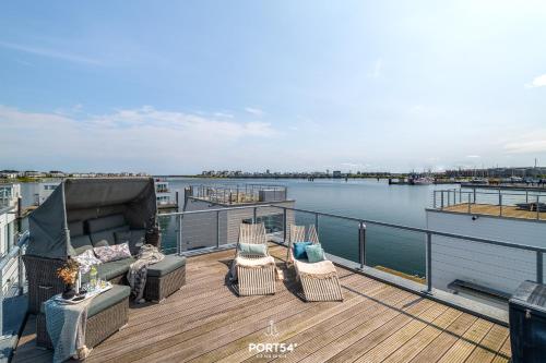 a balcony with chairs and a stage on a building at Ferienhaus Key West Olpenitz in Olpenitz