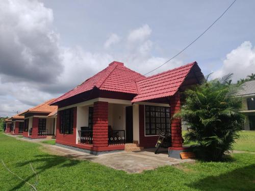 a small house with a red roof at Dubare Inn Coorg in Madikeri