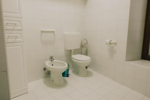 a bathroom with a toilet and a bidet at Cavour Luxury Apartments in Verona