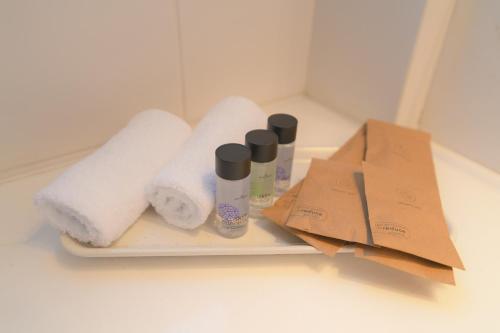 a tray with towels and toilet paper on a counter at Acropolis Hill House in Athens