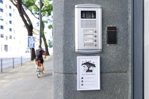 a pay meter on a wall with a person riding a bike at LEO Apartment FREE PARKING - President Palace in Bratislava