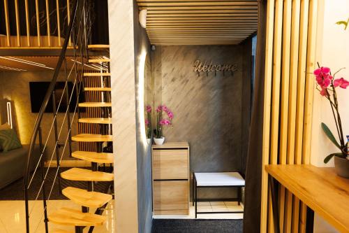 a spiral staircase in a room with a table and chairs at LEO Apartment FREE PARKING - President Palace in Bratislava