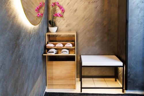 a shelf with a pair of shoes and a table at LEO Apartment FREE PARKING - President Palace in Bratislava