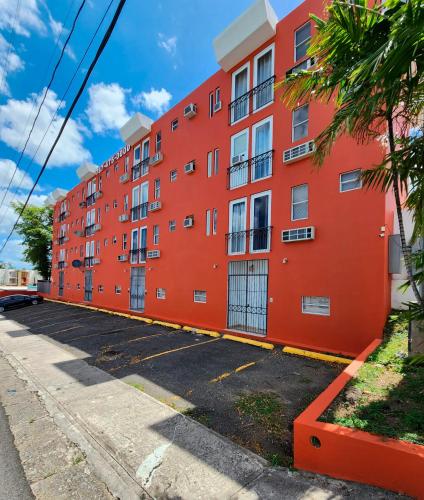 an orange building on the side of a street at Boulevard Park IV 303 in Mayaguez