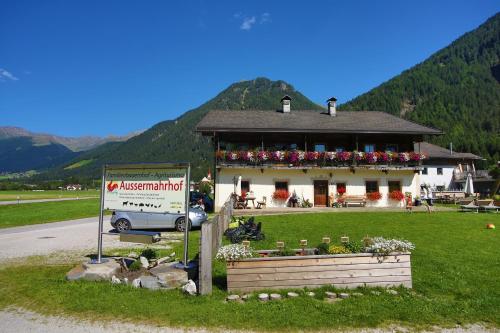 a building with a sign in front of it at Aussermahrhof - familyfarm in Gsies