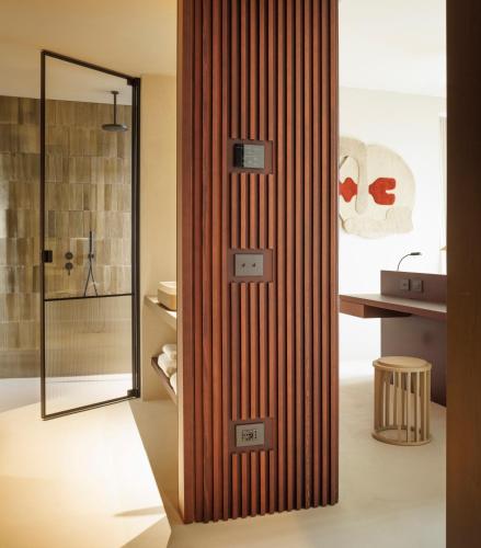 a bathroom with a wooden partition with a shower at Capitolo Riviera in Genova