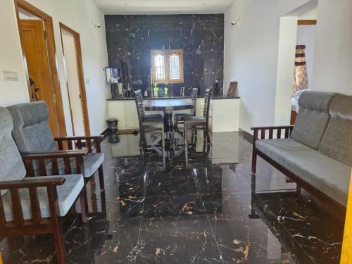 a living room with a dining room table and chairs at Ecstatic Stay - Beautiful 2BHK Cottage, Resort, Villa, HomeStay in Kodaikanal in Kodaikānāl