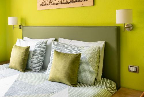 a bedroom with a bed with green walls and pillows at Chalet Rosita in Livigno