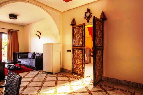a living room with a refrigerator and a couch at Auberge Kenza in Tahannout