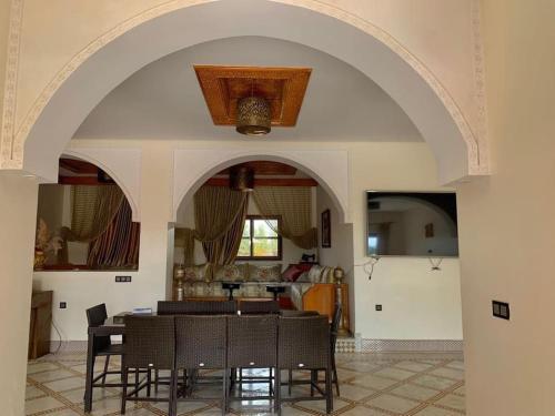 a dining room with a table and some chairs at Auberge Kenza in Tahannout
