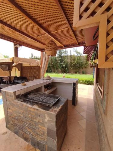a patio with an outdoor grill in a building at Auberge Kenza in Tahannout
