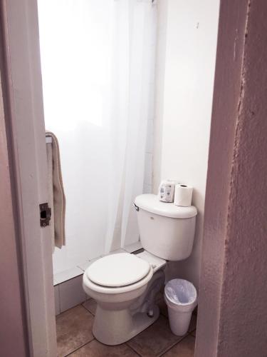 a white bathroom with a toilet and a window at Boulevard Park IV 305 in Mayaguez