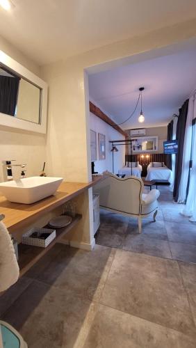 a large bathroom with a sink and a bedroom at La Belle San Isidro Lofts in San Isidro