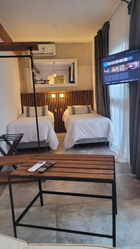 a hotel room with two beds and a bench at La Belle San Isidro Lofts in San Isidro