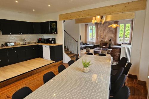 a kitchen and a dining room with a table and chairs at Gite le kayackou in Pont-d'Ouilly