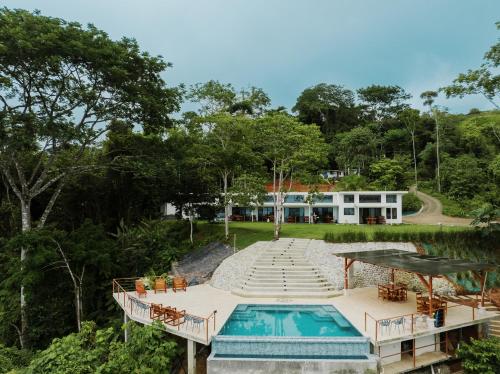 a resort with a swimming pool and a house at Canavida Villas & Resort in Uvita