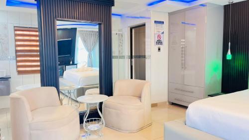 a hotel room with two beds and two chairs at Boeketlong Lodge in Jane Furse