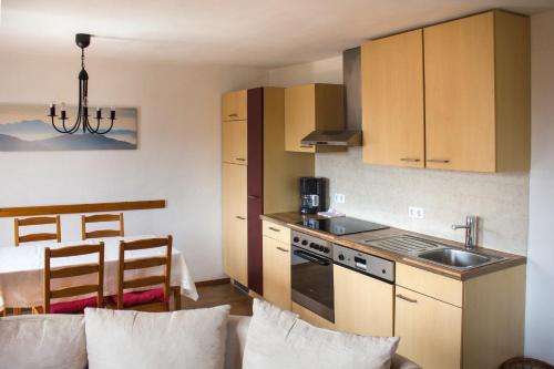 a small kitchen with a sink and a stove at Bauernhof Kronsteiner in Weyregg