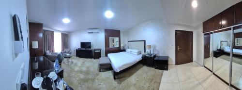 a hotel room with a bed and a television at Le Vendome Hotel in Amman