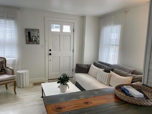 a living room with a couch and a table at An authentic, rustic luxurious little single family home in Old Town. All yours. in Marblehead