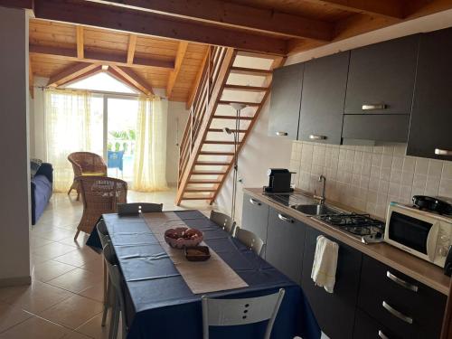 a kitchen with a table with a blue table cloth at Soleil A9 in Santa Maria