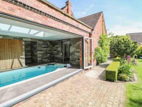 an external view of a house with a swimming pool at The Chapel - A Hidden Gem with Private Pool & Bar in Stone