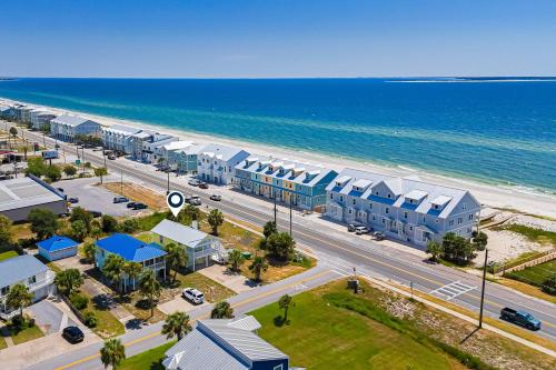 an aerial view of a beach with buildings and the ocean at Tranquil Seas in Saint Joe Beach