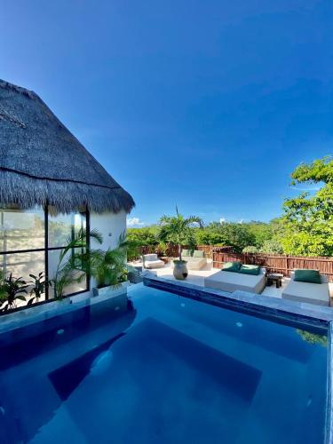 a villa with a swimming pool with a view at Luxury Jungle Penthouse with Private Rooftop Pool in Chemuyil