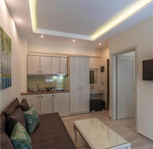 a living room with a couch and a table at Studios Kierion #1 in Skala Potamias