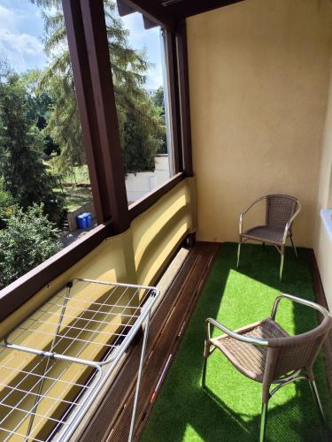 a balcony with two chairs and two windows at Cocon Zeitz in Zeitz