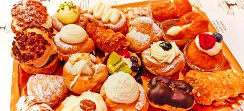 a tray filled with lots of pastries and desserts at Relax Destinazione Abruzzo-Molise in Forlì del Sannio