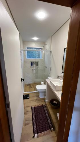 a bathroom with a shower and a toilet and a sink at Casa com Conforto, Tranquilidade em Meio à Natureza in Gonçalves