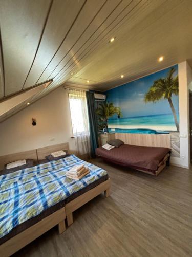 a bedroom with two beds and a painting of the beach at Sanpic in Sanzhiyka