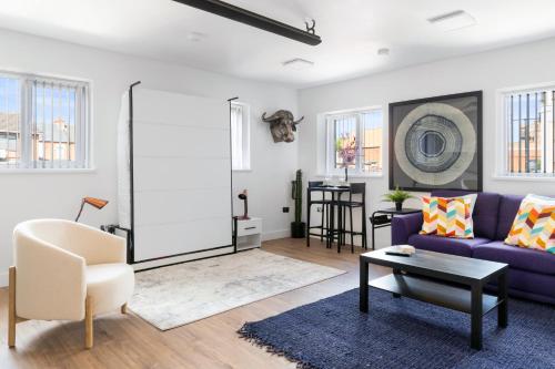 a living room with a purple couch and a table at Small Studio Arnold town Center e in Nottingham