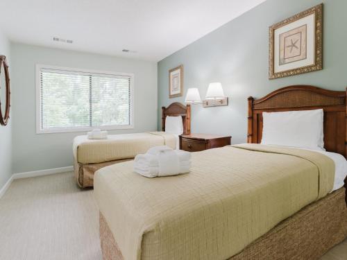 a bedroom with two beds and a window at Southwind II at Shipyard in Hilton Head Island