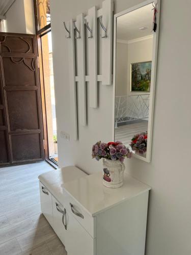 a bathroom with a white vanity and a mirror at VILLAge GOGHT in Goghtʼ