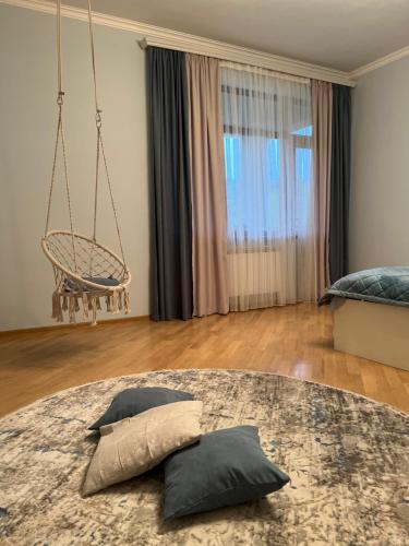 a living room with a couch and a swing at VILLAge GOGHT in Goghtʼ