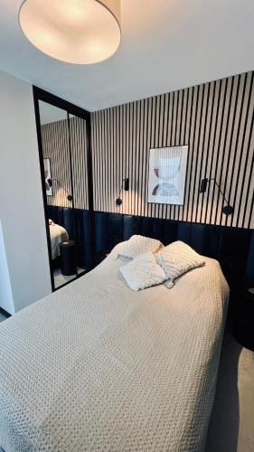 Un dormitorio con una cama y un espejo grande. en Apartament Morski Chill, en Jastrzębia Góra