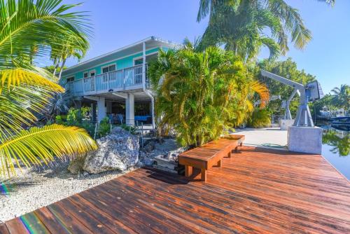 a wooden deck with benches in front of a building at Cedar Cottage in Big Pine Key