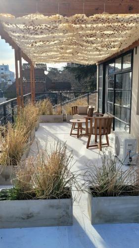 a patio with a table and chairs on a building at La Belle San Isidro Lofts in San Isidro