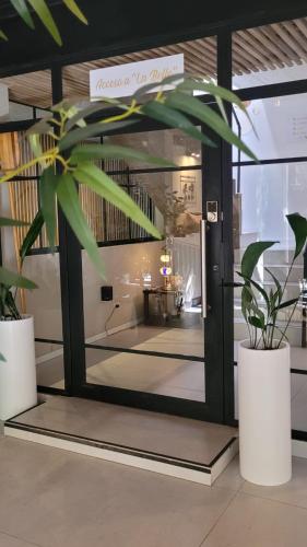 a lobby with a glass door with a potted plant at La Belle San Isidro Lofts in San Isidro