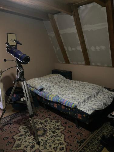 a room with a camera on a tripod next to a bed at Izletiste Pocivala in Podgorica